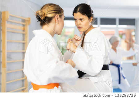 Two young women training karate techniques Two young women training karate techniques 138288729