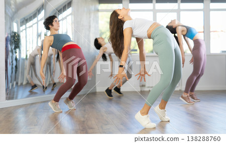Sporty woman dancing modern dance at class with his friends 138288760