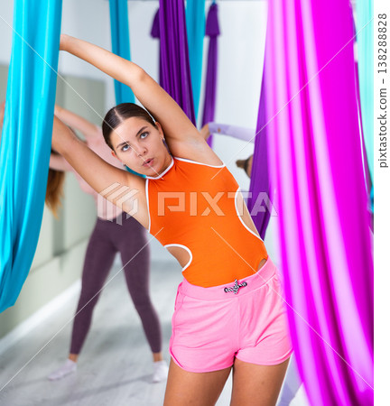 Young girls are warming up before doing aerial yoga 138288828