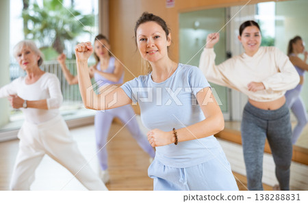 Active middle-aged woman practicing aerobic dance in training hall Active middle-aged woman practicing aerobic dance in training hall 138288831