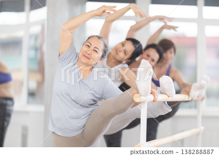 Ballet pose grand batman - women of different ages at choreography lesson Ballet pose grand batman - women of different ages at choreography lesson 138288887