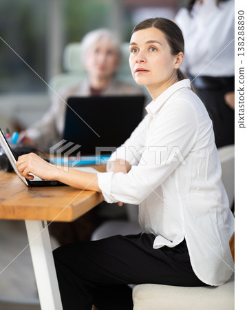 Businesswoman courses visitor at meeting listens to teacher and look to presentation. 138288890