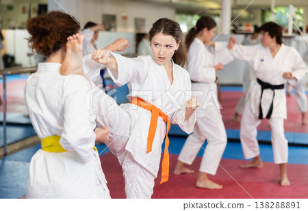 Women practice karate techniques in pairs Women practice karate techniques in pairs 138288891