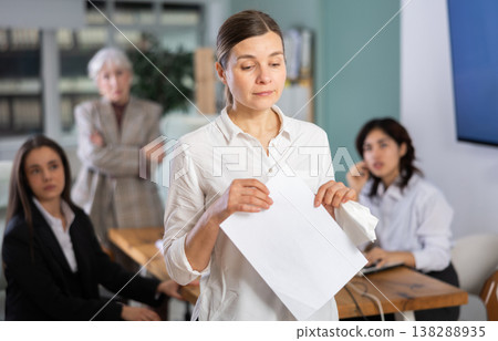 Upset middle-aged female employee leaving office Upset middle-aged female employee leaving office 138288935
