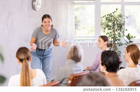 Woman tells an interesting story. Female students listening carefully in classroom 138288955