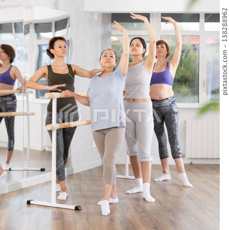 Group of women participating beginner ballet class with instructor Group of women participating beginner ballet class with instructor 138288962