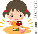 A girl eating a meal of rice, pickles, and miso soup. 138291219