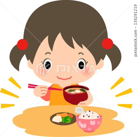 A girl eating a meal of rice, pickles, and miso soup. A girl eating a meal of rice, pickles, and miso soup. 138291219