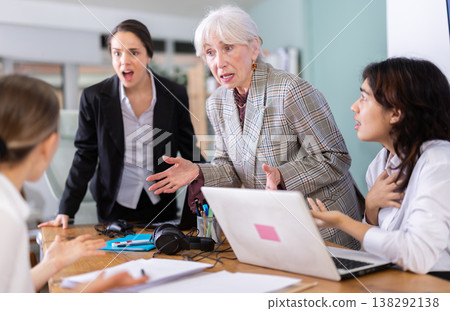Group of women arguing and scolding each other at office table Group of women arguing and scolding each other at office table 138292138