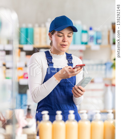 Young woman worker scanning qr code of cream 138292148