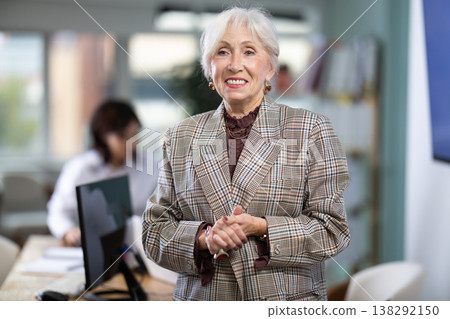 Mature woman welcoming clients at workplace Mature woman welcoming clients at workplace 138292150