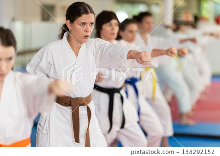 Group of women training karate techniques in studio Group of women training karate techniques in studio 138292152