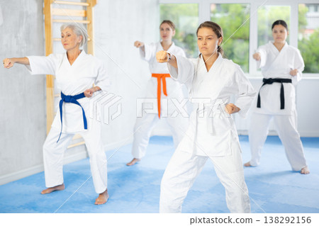 Athletes have starting position and repeating sequence of punches and painful techniques in kata Athletes have starting position and repeating sequence of punches and painful techniques in kata 138292156