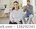 Upset woman and angry partner during couple conflict and argument in living room 138292341