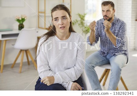 Upset woman and angry partner during couple conflict and argument in living room 138292341