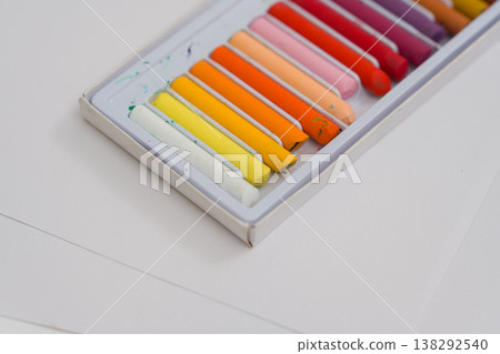 Set of oil pastels in box with white paper. Crayons Set of oil pastels in box with white paper. Crayons 138292540