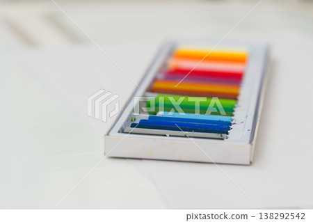 Set of oil pastels in box with white paper. Crayons 138292542