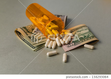 Pills and cash on a flat surface showing a financial situation 138293064