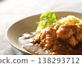 A close-up of chicken and beef curry with plenty of meat, served over saffron rice. 138293712