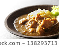 A close-up of chicken and beef curry with plenty of meat, served over saffron rice. 138293713