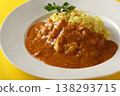 A close-up of chicken and beef curry with plenty of meat, served over saffron rice. 138293715