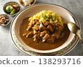 A close-up of chicken and beef curry with plenty of meat, served over saffron rice. 138293716