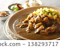 A close-up of chicken and beef curry with plenty of meat, served over saffron rice. 138293717
