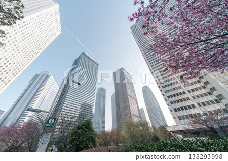 新宿副城區的摩天大樓和盛開的櫻花在晴朗的春日天空下巍然聳立。 新宿副城區的摩天大樓和盛開的櫻花在晴朗的春日天空下巍然聳立。 138293998