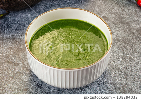 Green Spinach vegetable soup in a bowl with fresh avocado and chili peppers 138294032