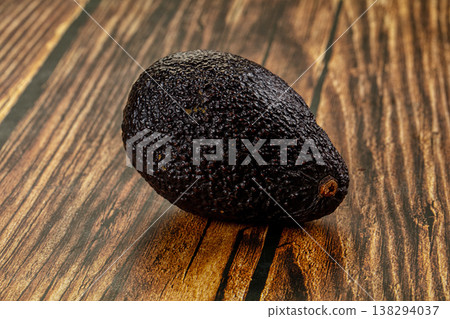 Whole ripe Hass avocados on a textured grey stone background. Whole ripe Hass avocados on a textured grey stone background. 138294037