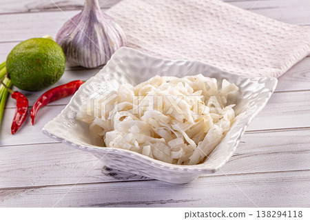 Cooked rice noodles in a white bowl with fresh lime, garlic, and chili peppers Cooked rice noodles in a white bowl with fresh lime, garlic, and chili peppers 138294118
