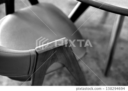 Black and white photograph: A wooden armchair with soft, flowing curves. Black and white photograph: A wooden armchair with soft, flowing curves. 138294694