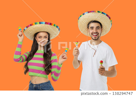 Couple enjoys Cinco de Mayo with hats and instruments Couple enjoys Cinco de Mayo with hats and instruments 138294747