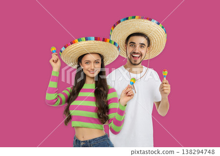 Young couple celebrates Cinco de Mayo with sombreros Young couple celebrates Cinco de Mayo with sombreros 138294748