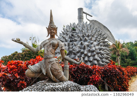 Durian monument with traditional Thai dancer statue and tropical plants Durian monument with traditional Thai dancer statue and tropical plants 138296049