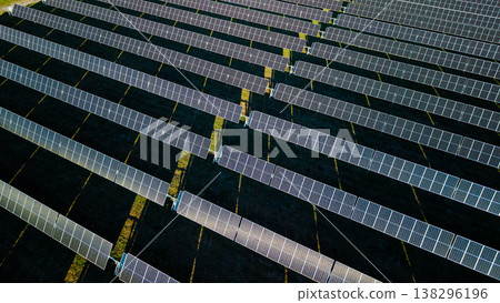 Aerial drone top view of solar farm with geometric rows of photovoltaic panels producing renewable energy Aerial drone top view of solar farm with geometric rows of photovoltaic panels producing renewable energy 138296196