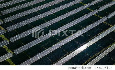 Aerial view of solar power station with parallel rows of photovoltaic panels generating renewable electricity Aerial view of solar power station with parallel rows of photovoltaic panels generating renewable electricity 138296198