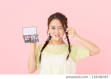 A young woman holding an eyeshadow palette A young woman holding an eyeshadow palette 138296367