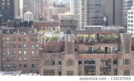 New York City Midtown East urban residential buildings, Manhattan rooftop, USA. Water towers on roof 138297068