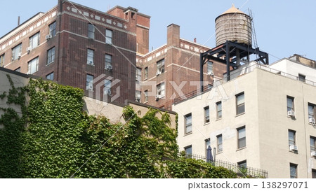 New York City urban building architecture, Manhattan rooftop, USA. Water tower on roof. Water tank. 138297071