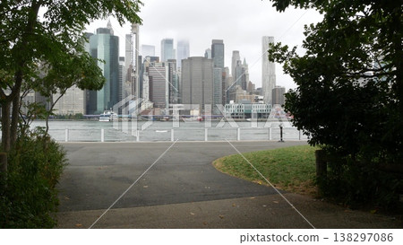 Manhattan downtown skyline from Brooklyn Bridge Park, New York City, USA. Skyscrapers, grass lawn. Manhattan downtown skyline from Brooklyn Bridge Park, New York City, USA. Skyscrapers, grass lawn. 138297086