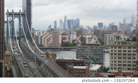 Manhattan bridge from roof in Brooklyn Dumbo, New York USA. City traffic, cars on road. Hudson Yards Manhattan bridge from roof in Brooklyn Dumbo, New York USA. City traffic, cars on road. Hudson Yards 138297264