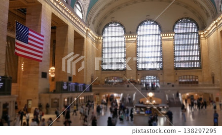 New York Grand Central Terminal on 42 street, USA. People and flag inside railway station building. New York Grand Central Terminal on 42 street, USA. People and flag inside railway station building. 138297295