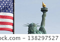 Statue of Liberty on Liberty Island, New York, USA. Flag and monument, patriotic symbol of democracy 138297527