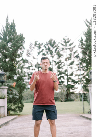 Southeast Asian man showing finger gesture with thumb and index finger outdoors 138298093