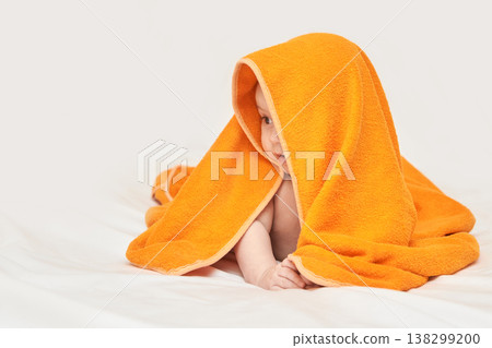 Caucasian Baby Under Orange Blanket On White Bed Smiling Playfully Caucasian Baby Under Orange Blanket On White Bed Smiling Playfully 138299200