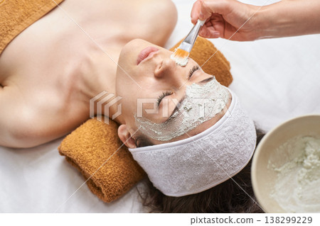 Female Relaxing During Facial Mask Treatment In Spa For Skincare Rejuvenation Female Relaxing During Facial Mask Treatment In Spa For Skincare Rejuvenation 138299229