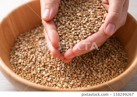 Raw organic buckwheat seeds in hand, Food ingredient Raw organic buckwheat seeds in hand, Food ingredient 138299267