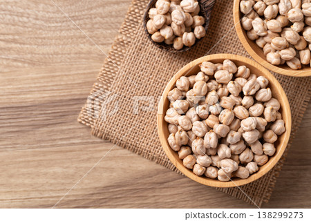 Organic raw chickpeas in a wooden bowl on wooden background, healthy food ingredient 138299273