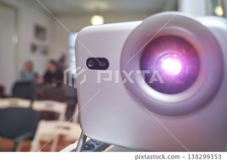 Bright projector in empty conference room with blurred background scene and defocused people 138299353